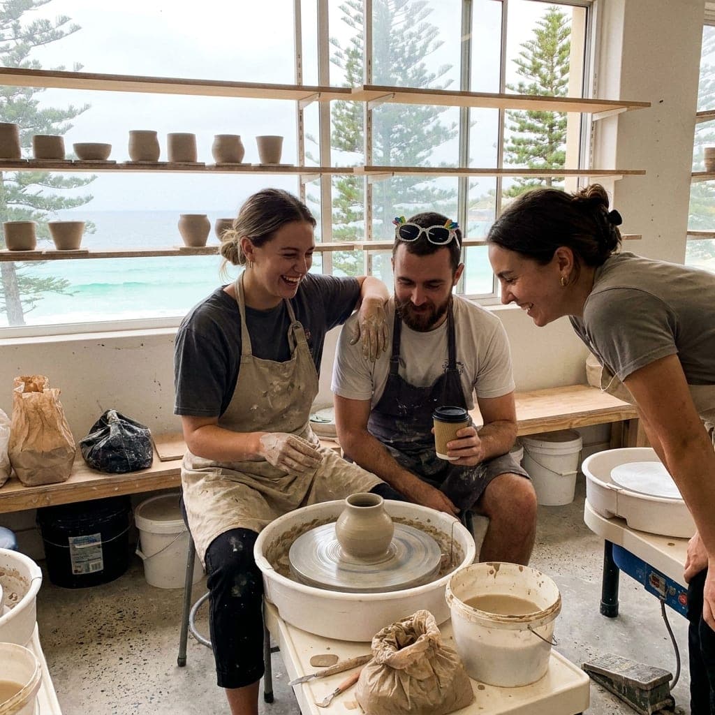 Clay-covered hands and laughter at a pottery class social
